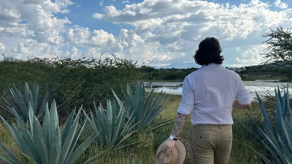 Liam Slater walking through agave fields in Mexico